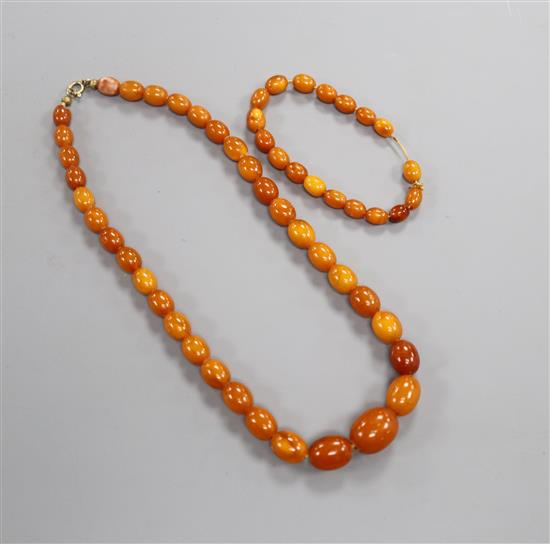 A single strand graduated oval amber bead necklace and a small amber bracelet, gross weight 19 grams, necklace 38.5cm